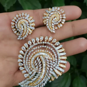 Bridal-style gold-plated paisley pendant set with sparkling CZ stones, including matching earrings, displayed on hand — premium designer jewellery by Risha Fine Jewels.