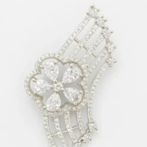 Close-up image of an Elegant Floral CZ Fan-Design Statement Ring for Women by Risha Fine Jewels, featuring a sparkling flower-shaped CZ centerpiece with cascading CZ-studded fan bars, held against a natural green leaf background.