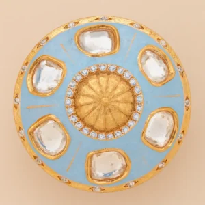 Close-up image of an Ethnic Kundan Statement Ring with Sky-Blue Meenakari Enamel for Women by Risha Fine Jewels, featuring a gold-toned dome centerpiece, surrounding Kundan stones, and handcrafted enamel detailing against a green leaf background.