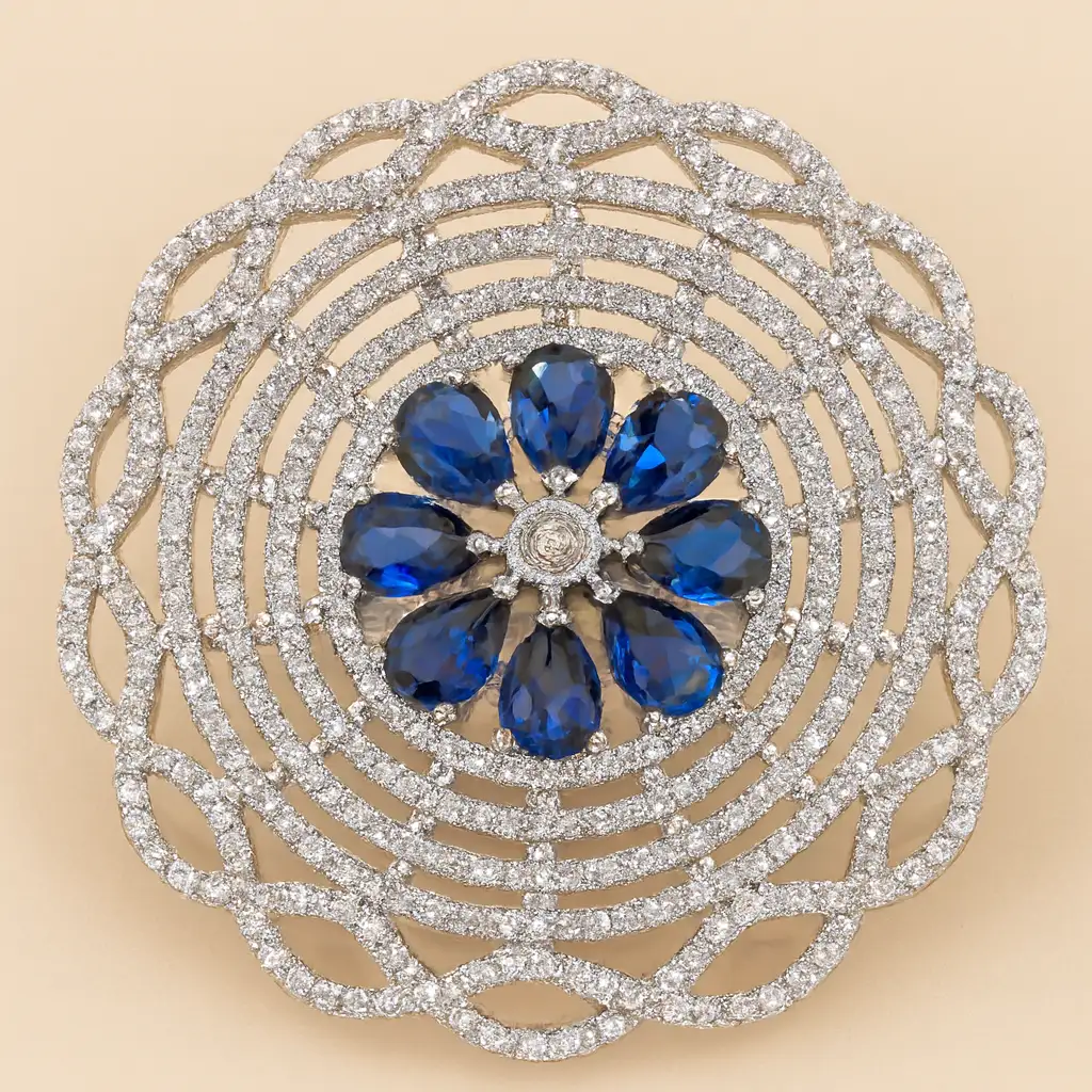 Royal Sapphire-Blue Floral CZ Lattice Statement Ring Close-up image of a Royal Sapphire-Blue Floral CZ Lattice Statement Ring by Risha Fine Jewels, featuring a sapphire-blue teardrop CZ floral cluster surrounded by an intricate multi-layered diamond-cut CZ lattice design, held against a natural green leaf background.