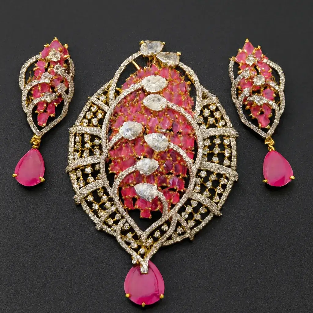 Ruby Pink Regal CZ Pendant Set for Women Ruby Pink Regal CZ Pendant Set with Matching Earrings – Gold-Plated Designer Bridal and Festive Jewelry by Risha Fine Jewels, featuring ruby-pink gemstones, sparkling CZ stones, and intricate lattice detailing.