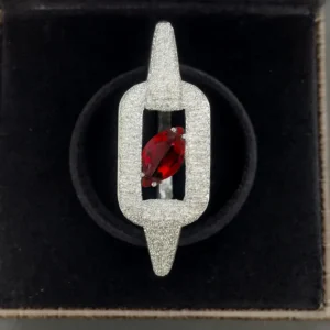 White-gold plated designer bracelet with a ruby-red pear-cut CZ stone set in a pave rectangular link frame by Risha Fine Jewels.