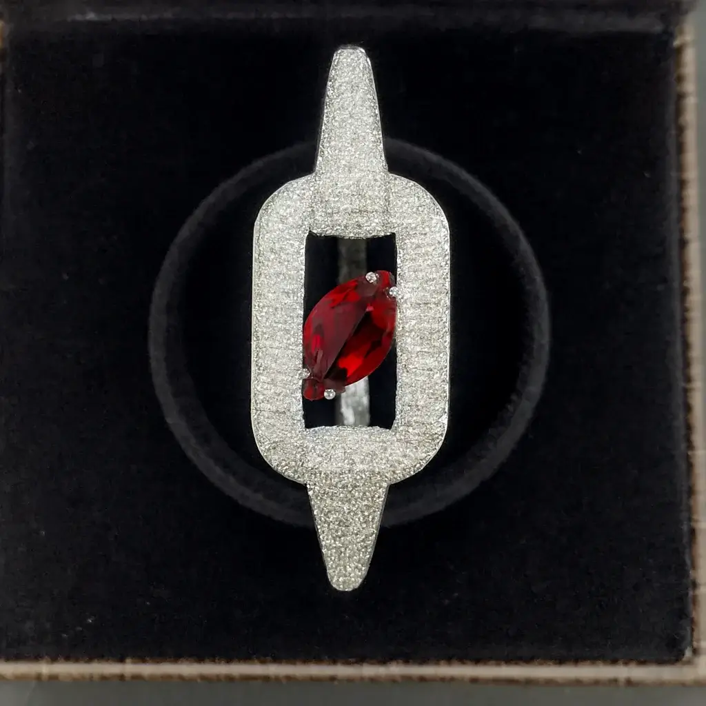 Ruby-Red Pear Cut CZ Link Frame Designer Bracelet White-gold plated designer bracelet with a ruby-red pear-cut CZ stone set in a pave rectangular link frame by Risha Fine Jewels.